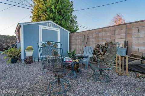 a view of backyard of house with outdoor seating and green space