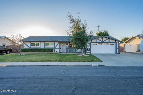 a view of a house with a yard and garage