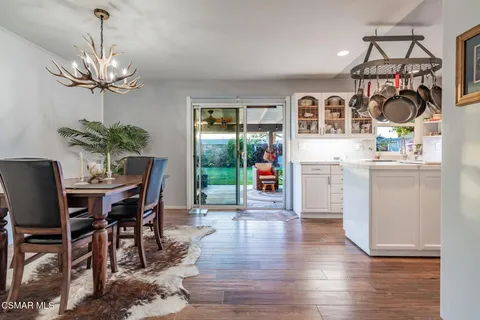 a view of a dining room with furniture wooden floor and chandelier