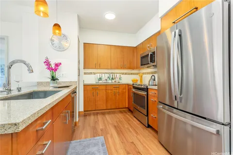 a kitchen with granite countertop a sink appliances and cabinets