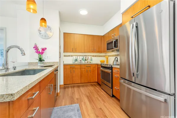 a kitchen with granite countertop a sink appliances and cabinets