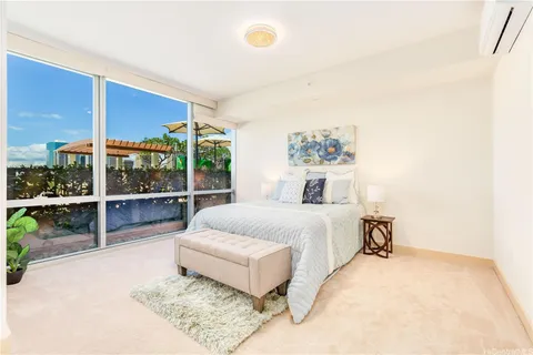 a bedroom with a bed and glass window