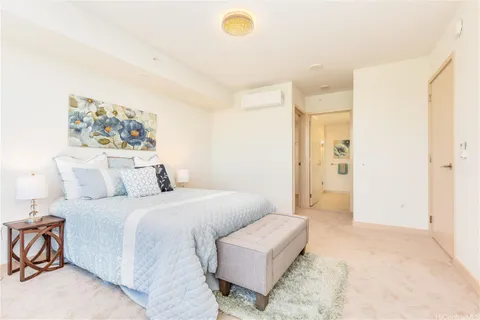 a bedroom with a bed and a painting on the wall