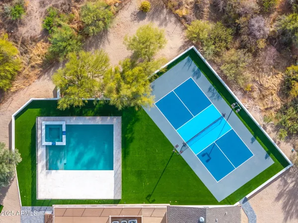 a view of a house with swimming pool and a yard