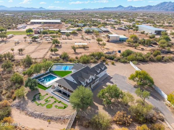 a bathroom with a granite countertop sink toilet and mirror
