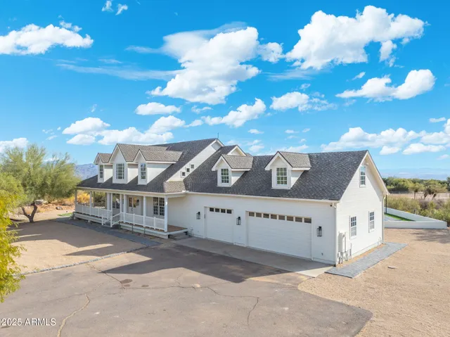 a bathroom with a granite countertop sink a mirror and a bathtub