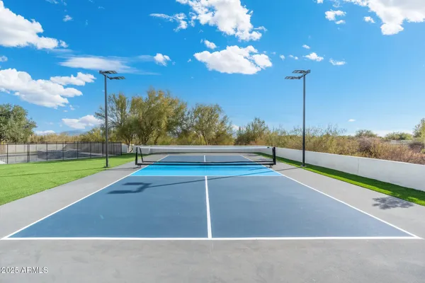 a large kitchen with granite countertop a sink dishwasher stove and cabinets with wooden floor