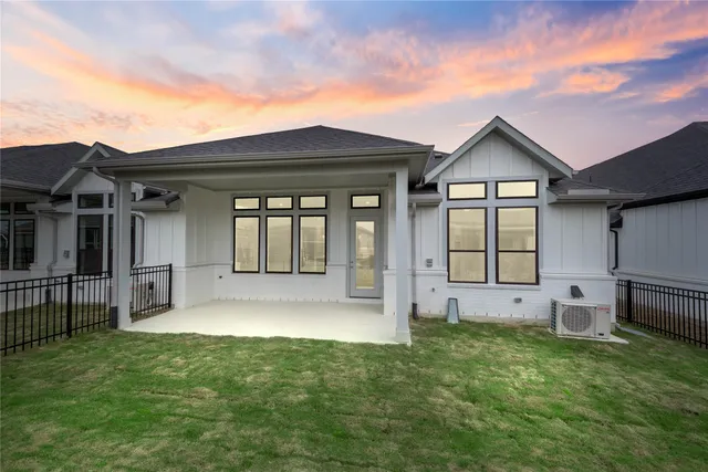 a front view of house with a yard and trees