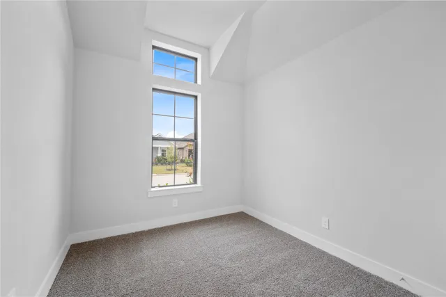 an empty room with closet and a hallway
