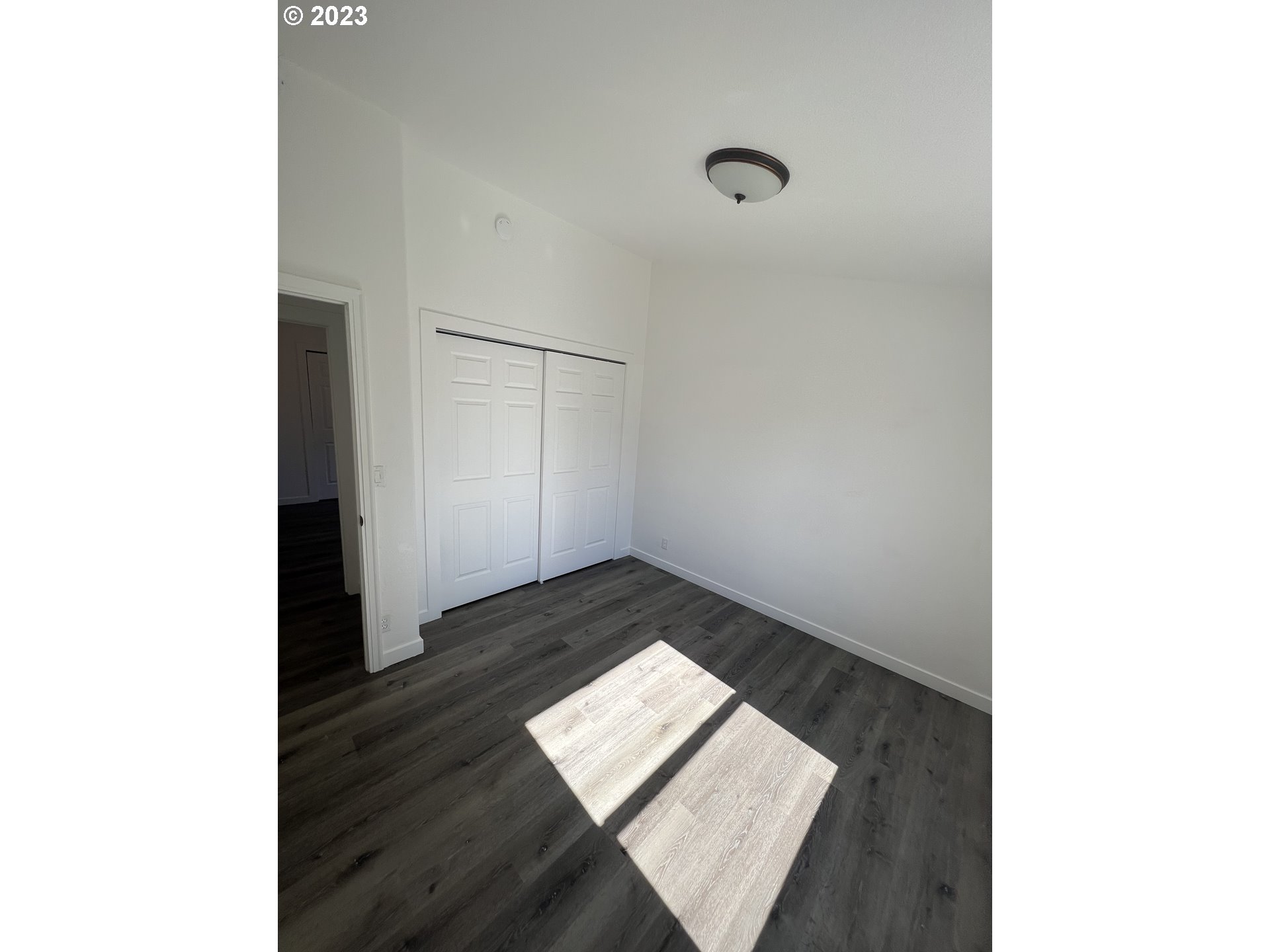 170 Fenton Avenue Molalla, OR 97038 - Photo 14 of 27 a view of an empty room with wooden floor and a window