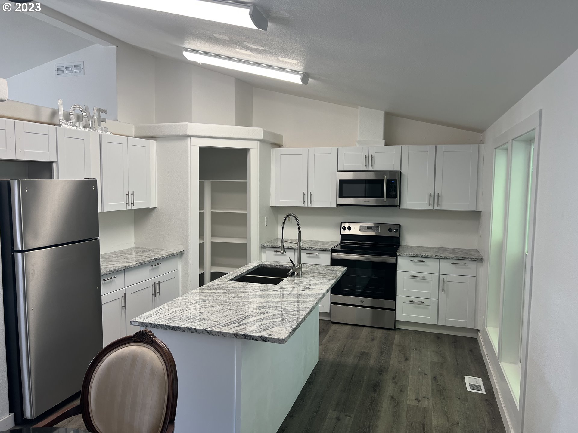 170 Fenton Avenue Molalla, OR 97038 - Photo 6 of 27 a kitchen with granite countertop a refrigerator stove top oven and sink
