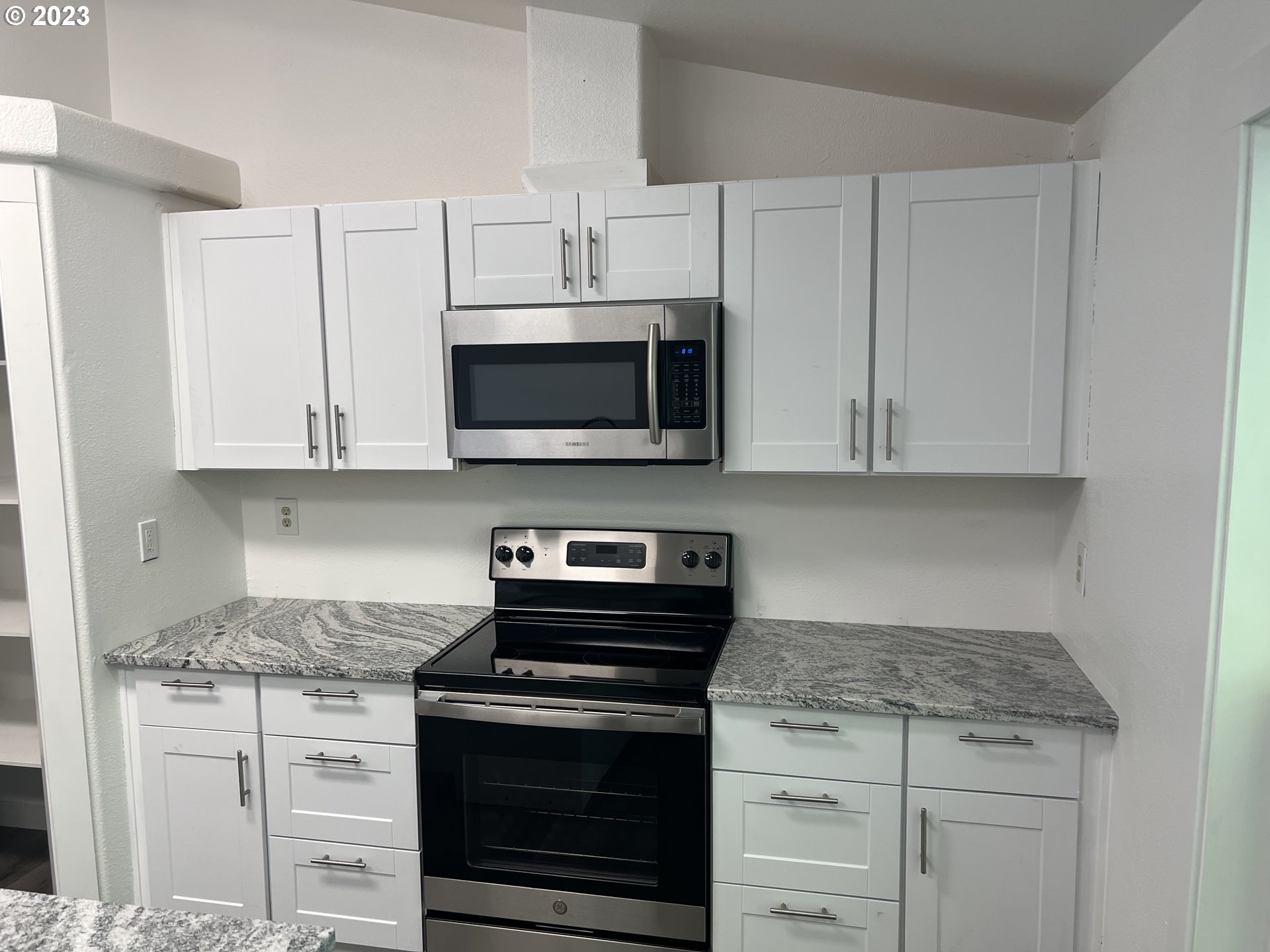 170 Fenton Avenue Molalla, OR 97038 - Photo 7 of 27 a kitchen with white cabinets and stainless steel appliances