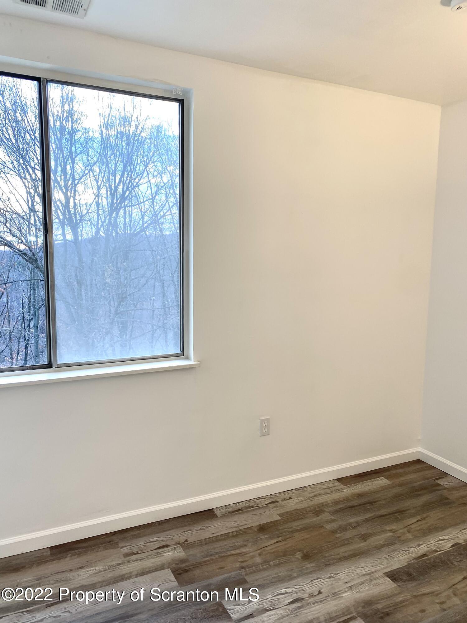 1111 Summit Pointe Scranton, PA 18508 - Photo 15 of 22 a view of a small space with wooden floor and a window