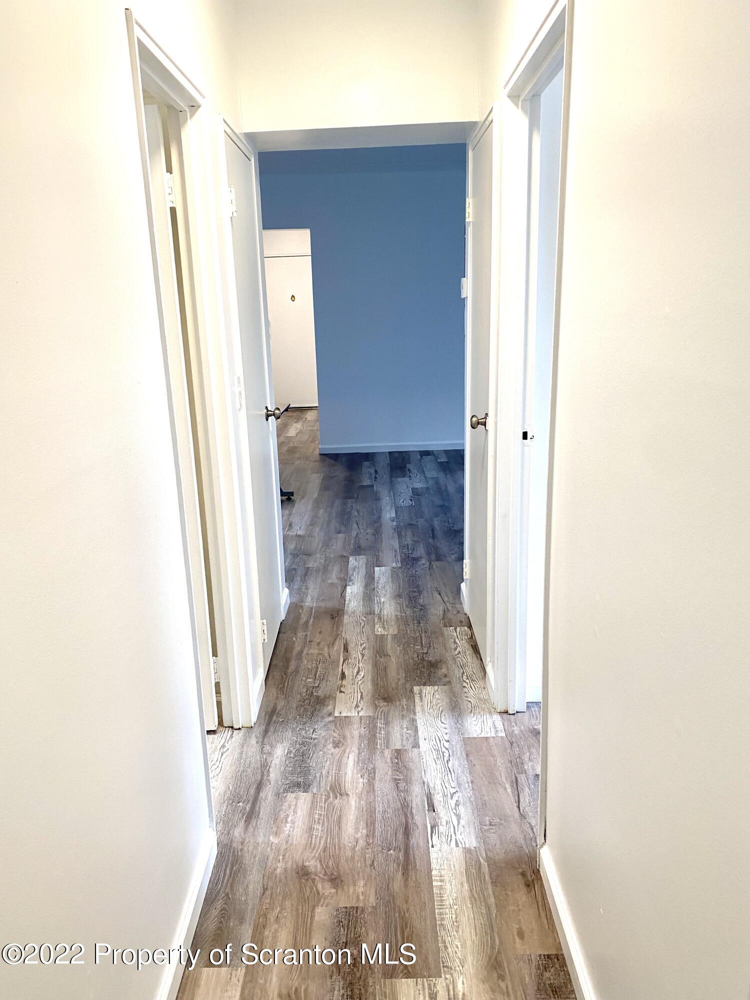 1111 Summit Pointe Scranton, PA 18508 - Photo 19 of 22 a view of a hallway with wooden floor