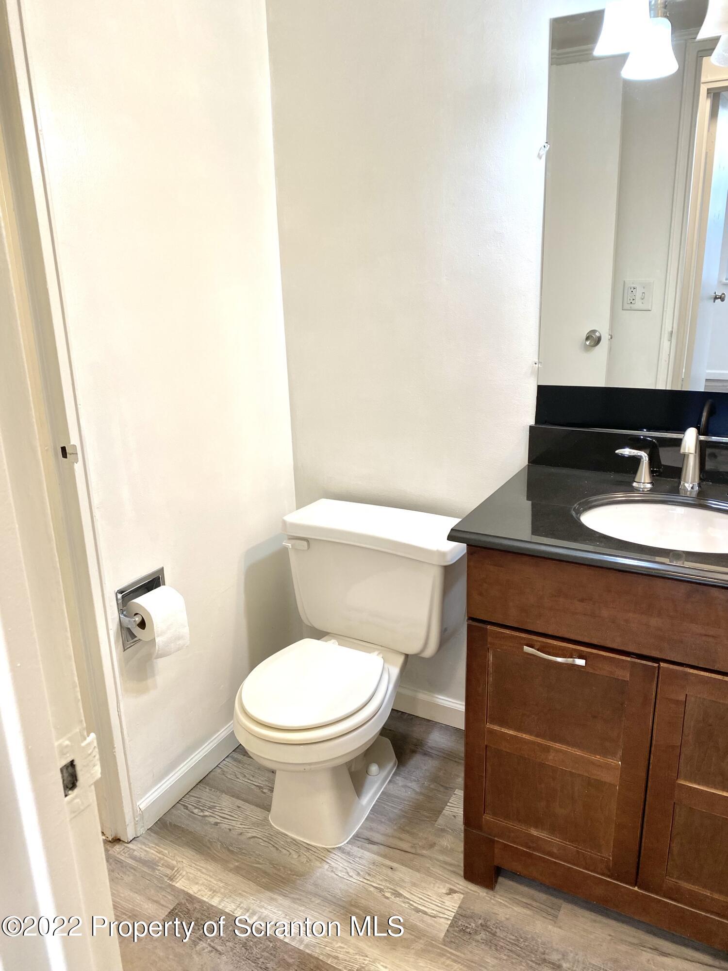 1111 Summit Pointe Scranton, PA 18508 - Photo 20 of 22 a bathroom with a toilet a sink and a mirror