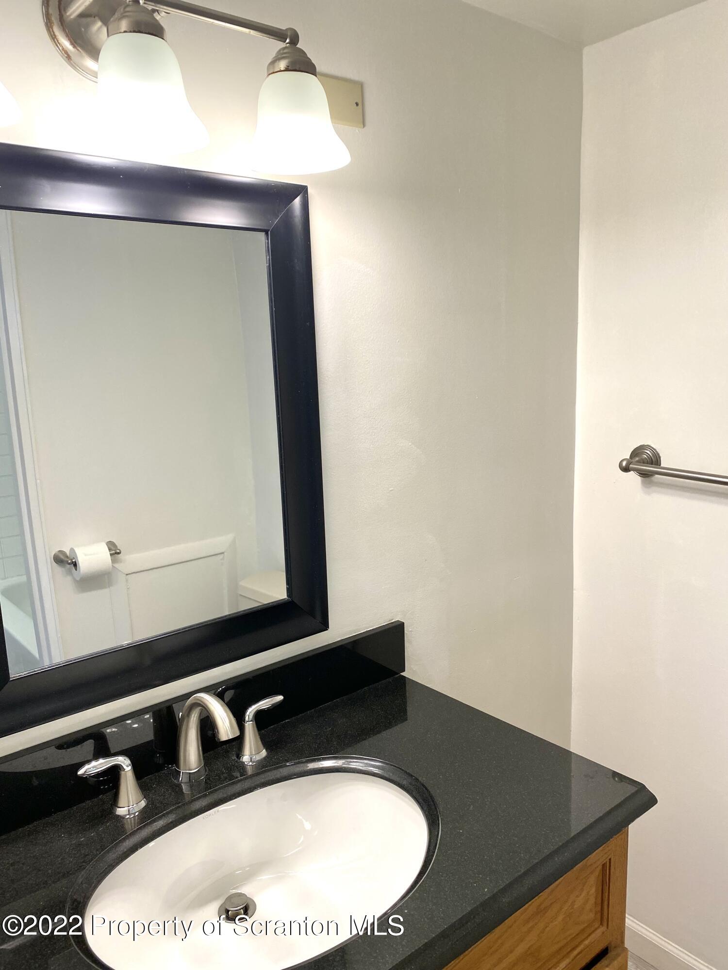1111 Summit Pointe Scranton, PA 18508 - Photo 21 of 22 a bathroom with a sink and a mirror