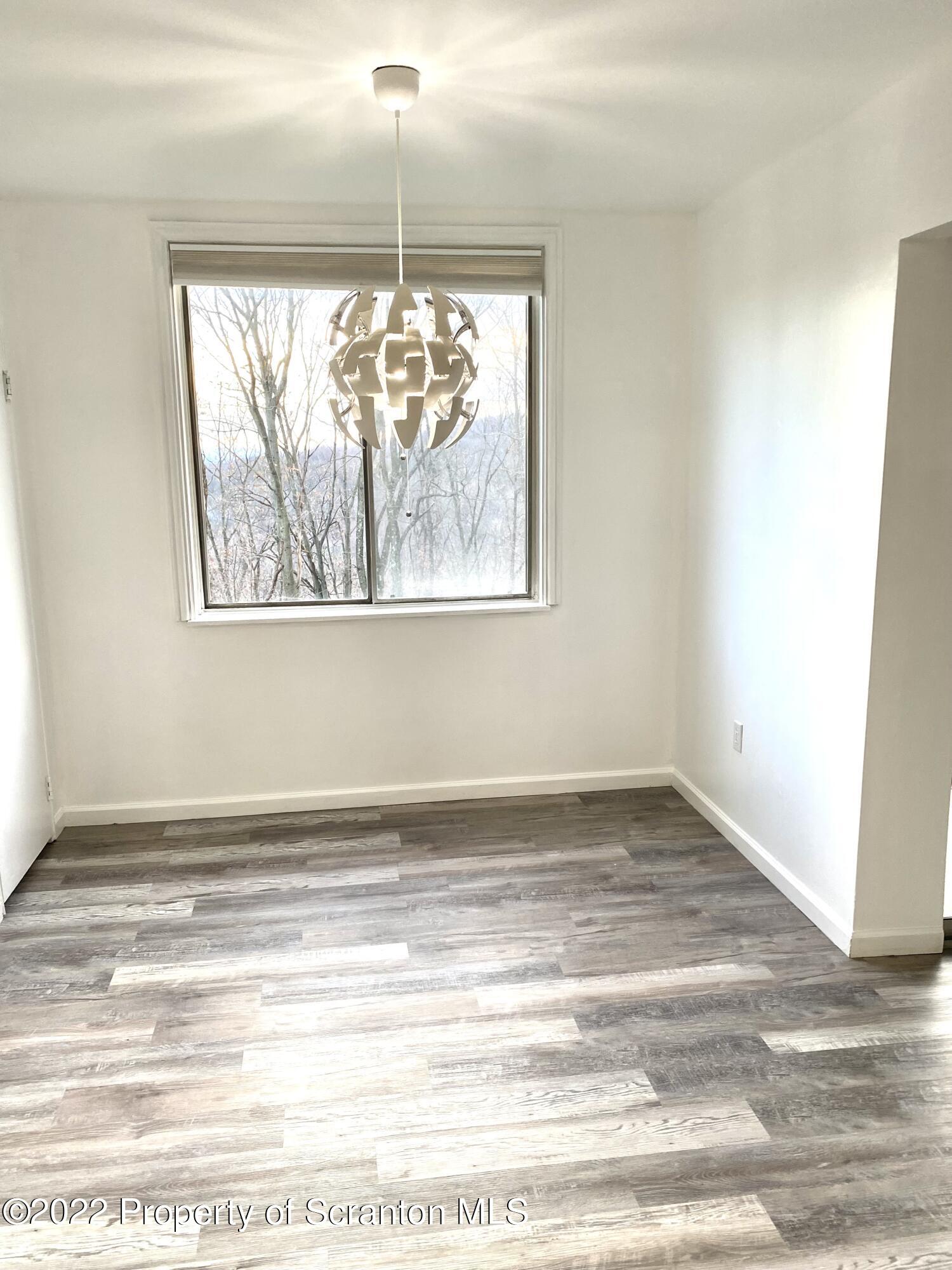 1111 Summit Pointe Scranton, PA 18508 - Photo 8 of 22 a view of empty room with window and wooden floor