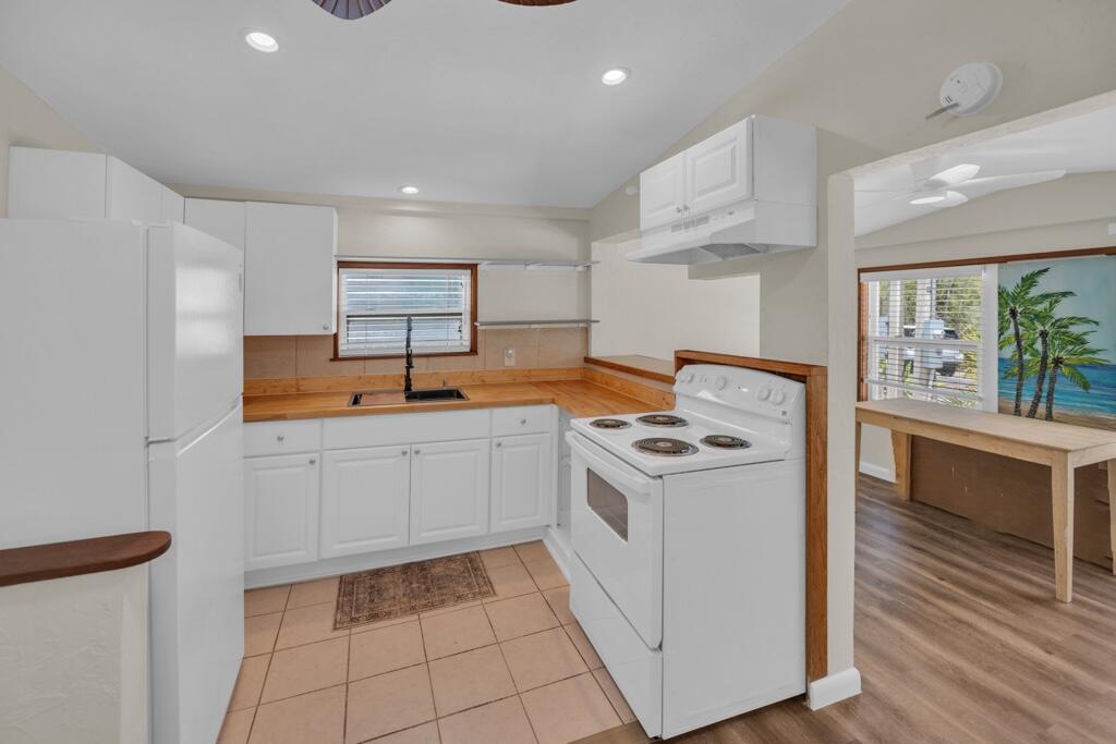 235 Antigua Road Tavernier, FL 33070 - Photo 3 of 48 a kitchen with a stove sink and cabinets