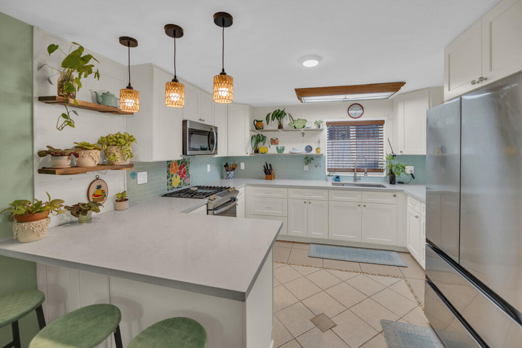235 Antigua Road Tavernier, FL 33070 - Photo 31 of 48 a kitchen with a sink refrigerator and cabinets