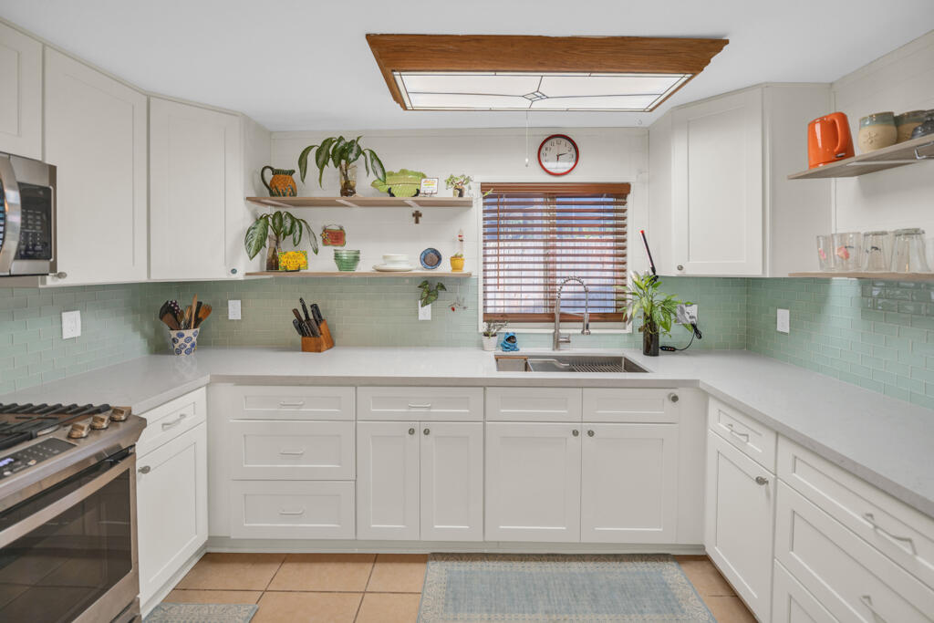 235 Antigua Road Tavernier, FL 33070 - Photo 32 of 48 a kitchen with white cabinets and window