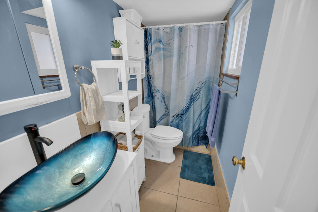 235 Antigua Road Tavernier, FL 33070 - Photo 34 of 48 a bathroom with a toilet and a mirror