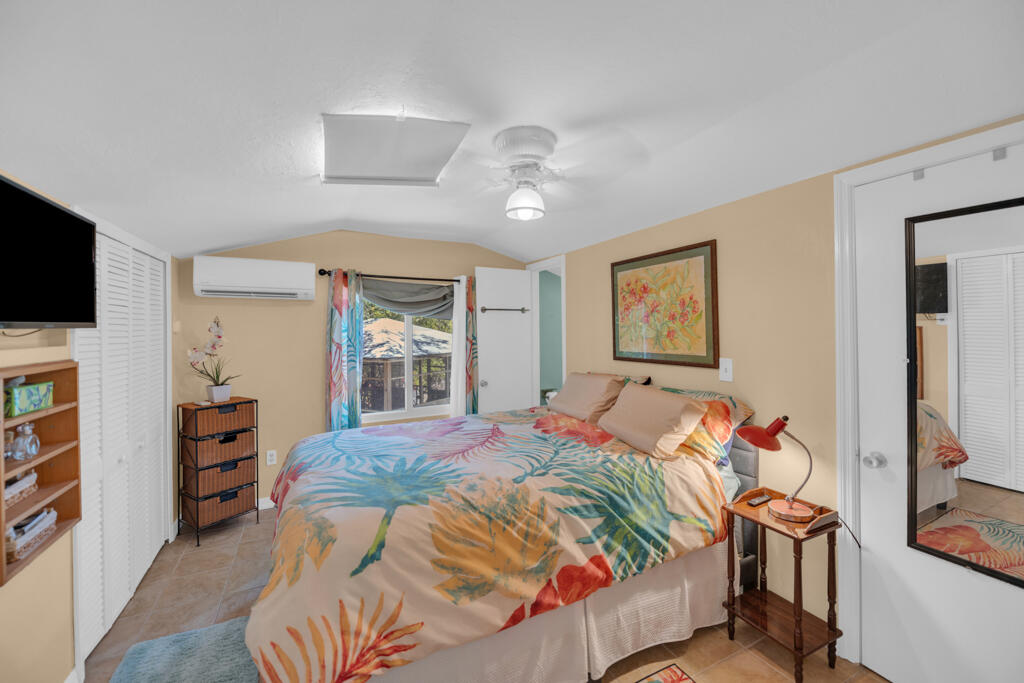 235 Antigua Road Tavernier, FL 33070 - Photo 36 of 48 a bedroom with a bed and a flat screen tv