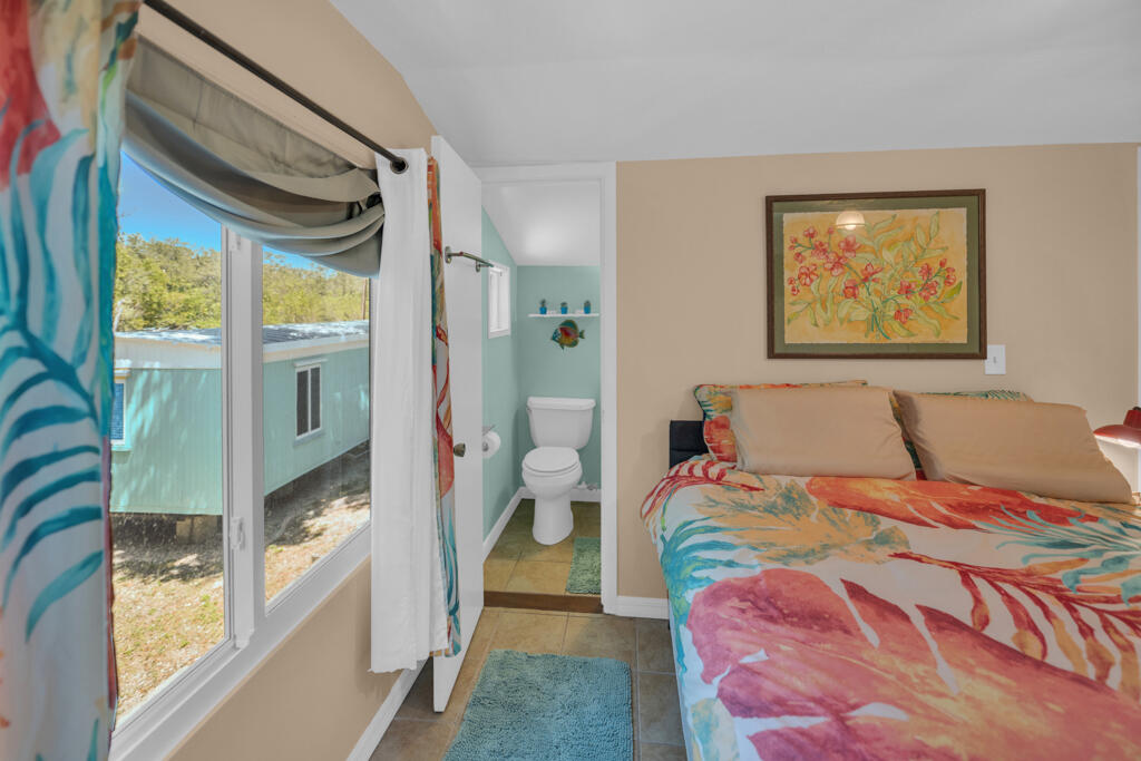 235 Antigua Road Tavernier, FL 33070 - Photo 38 of 48 a bedroom with a bed and a large window