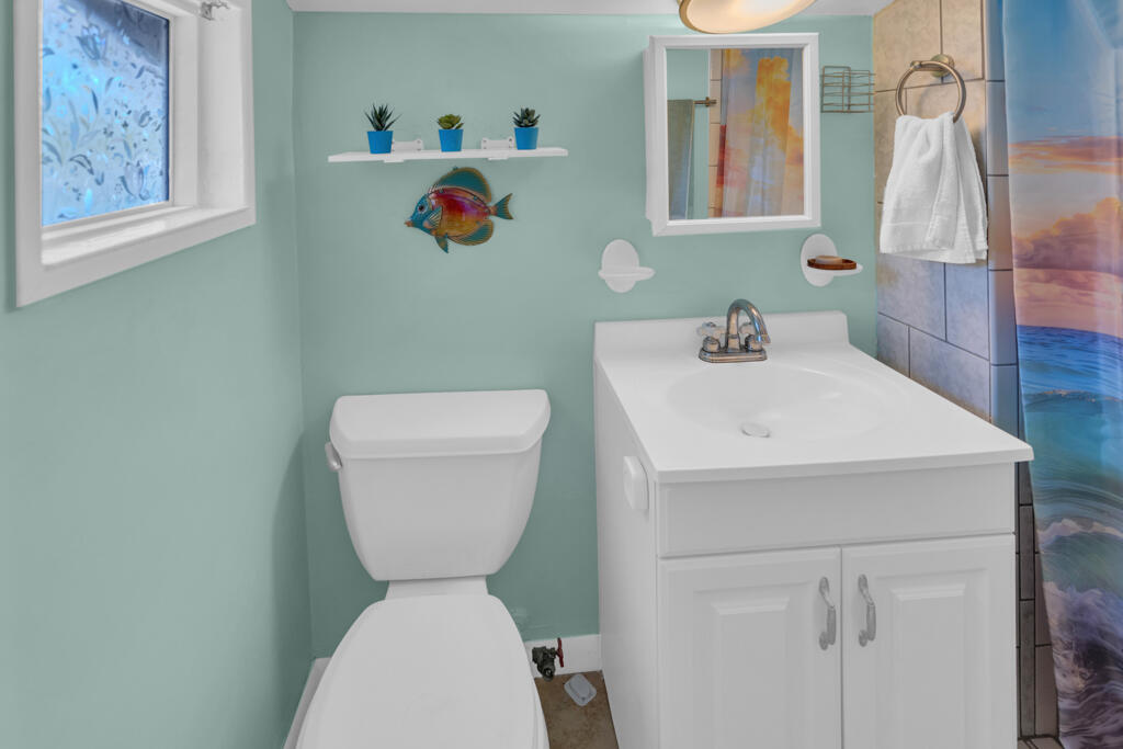 235 Antigua Road Tavernier, FL 33070 - Photo 39 of 48 a bathroom with a toilet sink and mirror