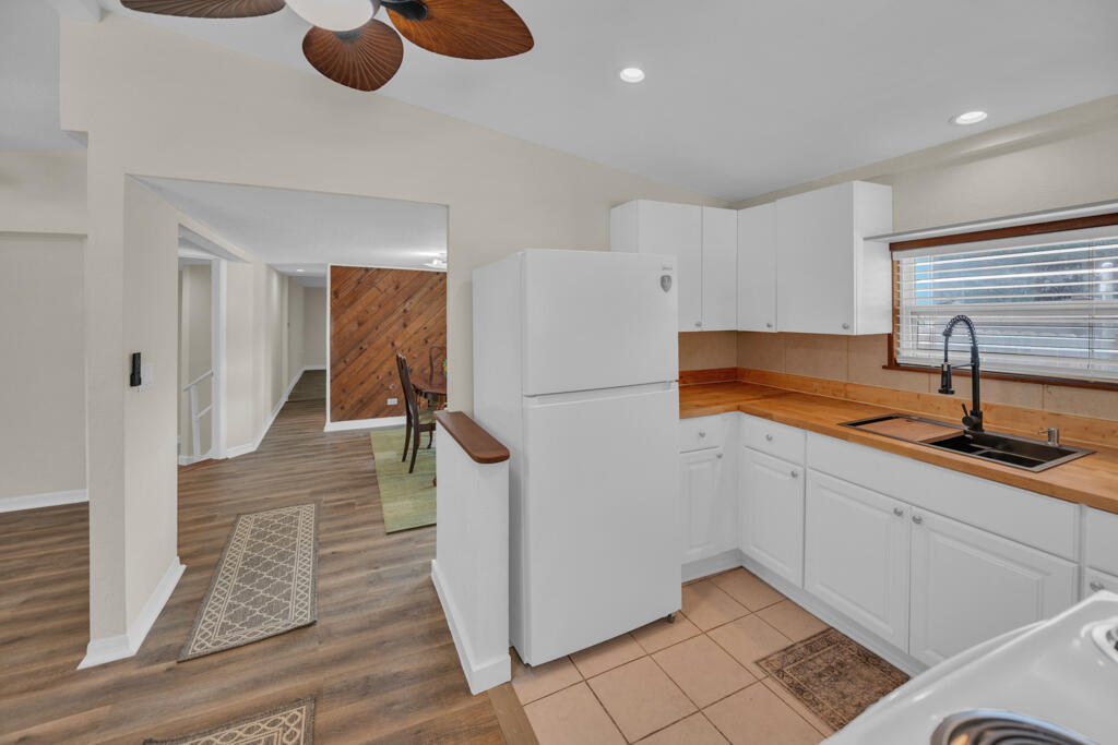 235 Antigua Road Tavernier, FL 33070 - Photo 4 of 48 a kitchen with sink refrigerator and window