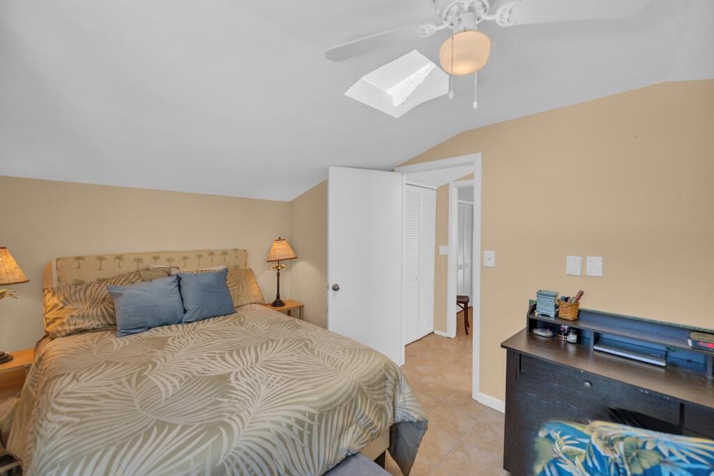 235 Antigua Road Tavernier, FL 33070 - Photo 41 of 48 a bedroom with a bed and a chandelier