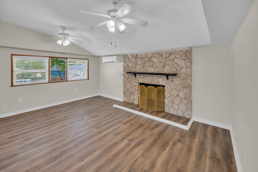 235 Antigua Road Tavernier, FL 33070 - Photo 6 of 48 wooden floor in an empty room with a fireplace