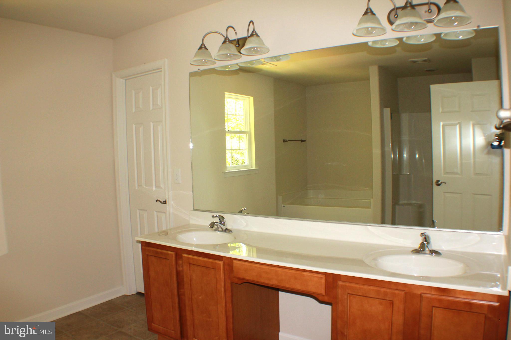 652 West Rocky Run Road Fredericksburg, VA 22406 - Photo 14 of 20 a bathroom with a double vanity sink mirror and