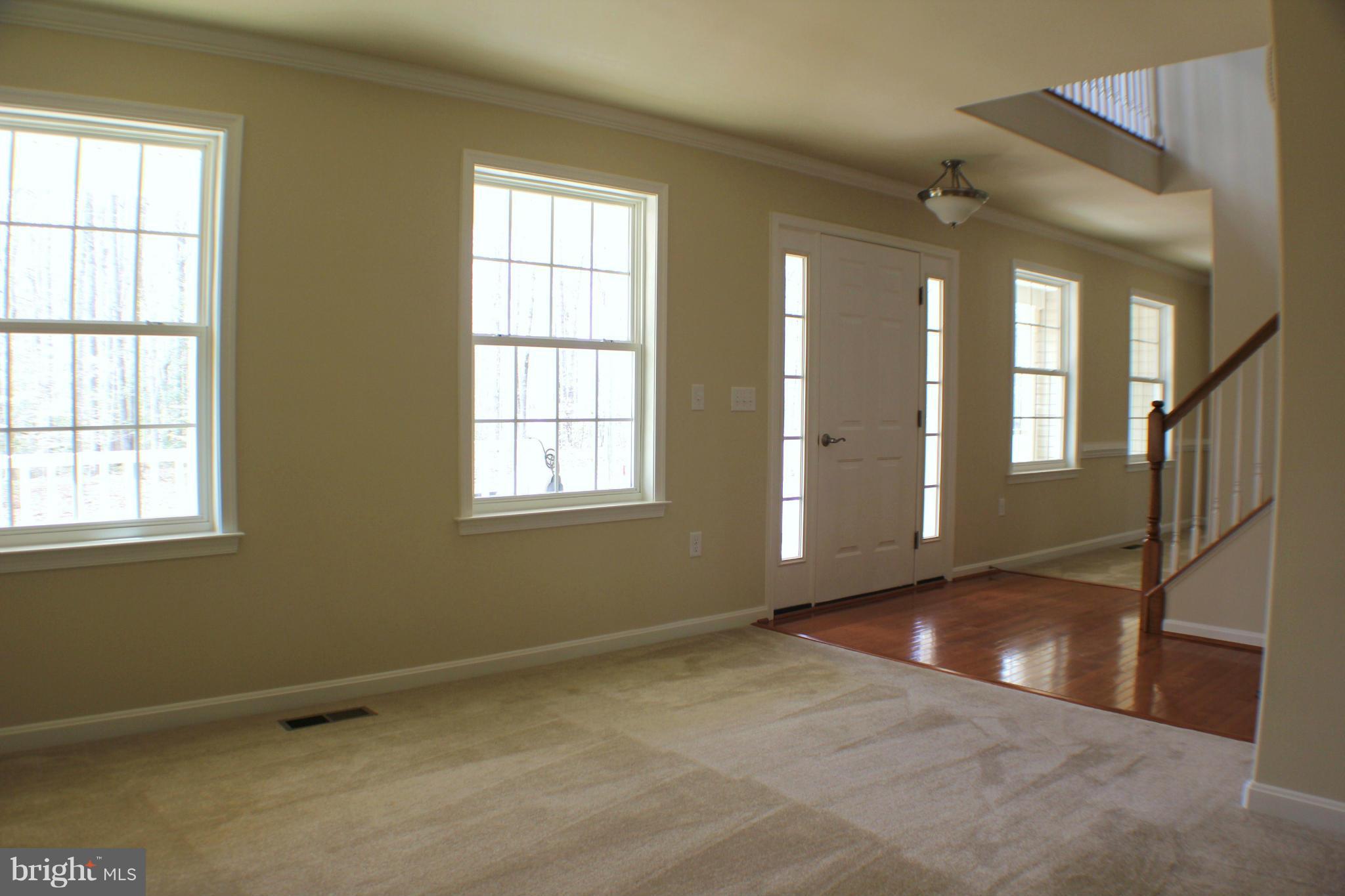 652 West Rocky Run Road Fredericksburg, VA 22406 - Photo 3 of 20 an empty room with wooden floor and windows