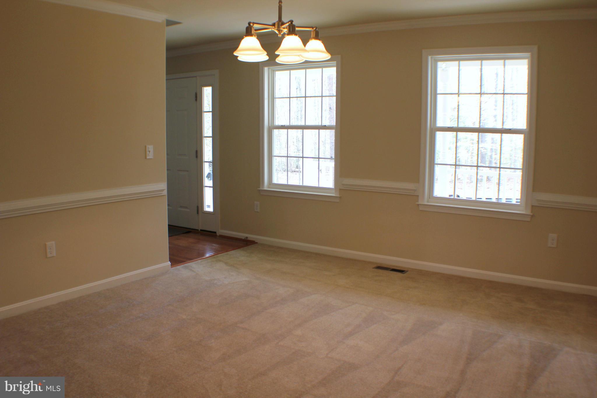 652 West Rocky Run Road Fredericksburg, VA 22406 - Photo 5 of 20 an empty room with chandelier and windows