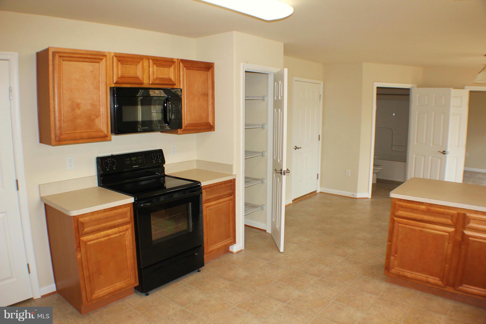 652 West Rocky Run Road Fredericksburg, VA 22406 - Photo 7 of 20 a kitchen with stainless steel appliances granite countertop a stove and a microwave