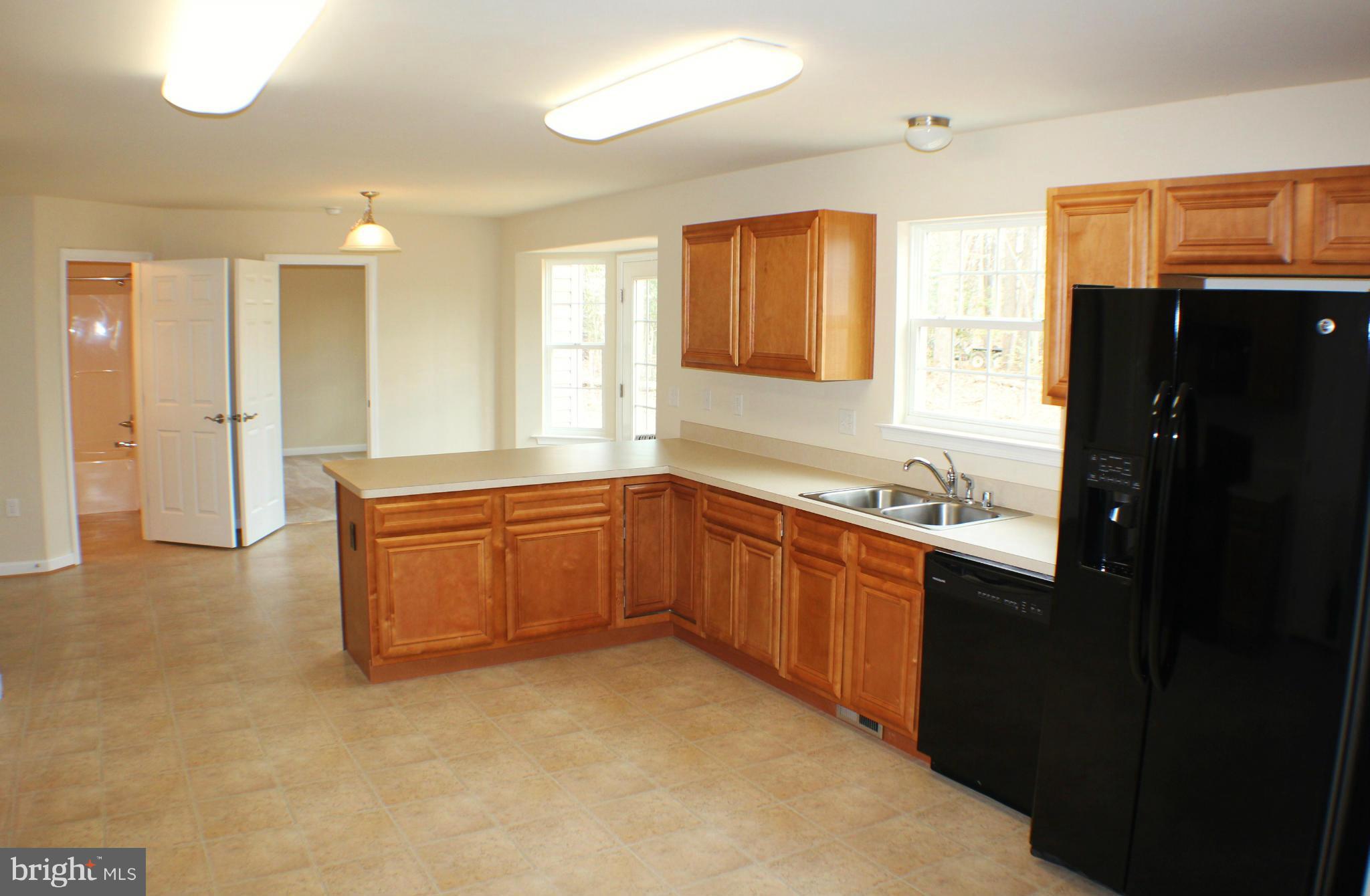 652 West Rocky Run Road Fredericksburg, VA 22406 - Photo 8 of 20 a kitchen with stainless steel appliances granite countertop a refrigerator and a sink