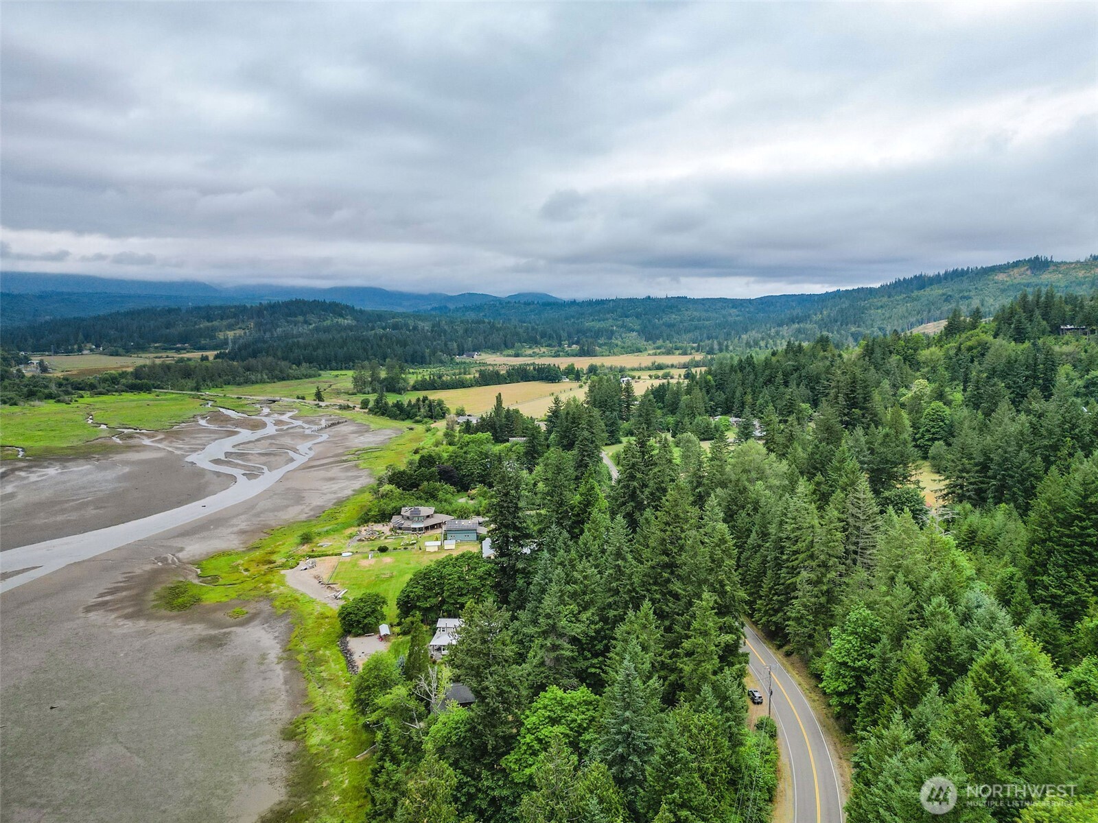 1310 East Quilcene Road Quilcene, WA 98376 - Photo 9 of 37 a view of a lake with a city