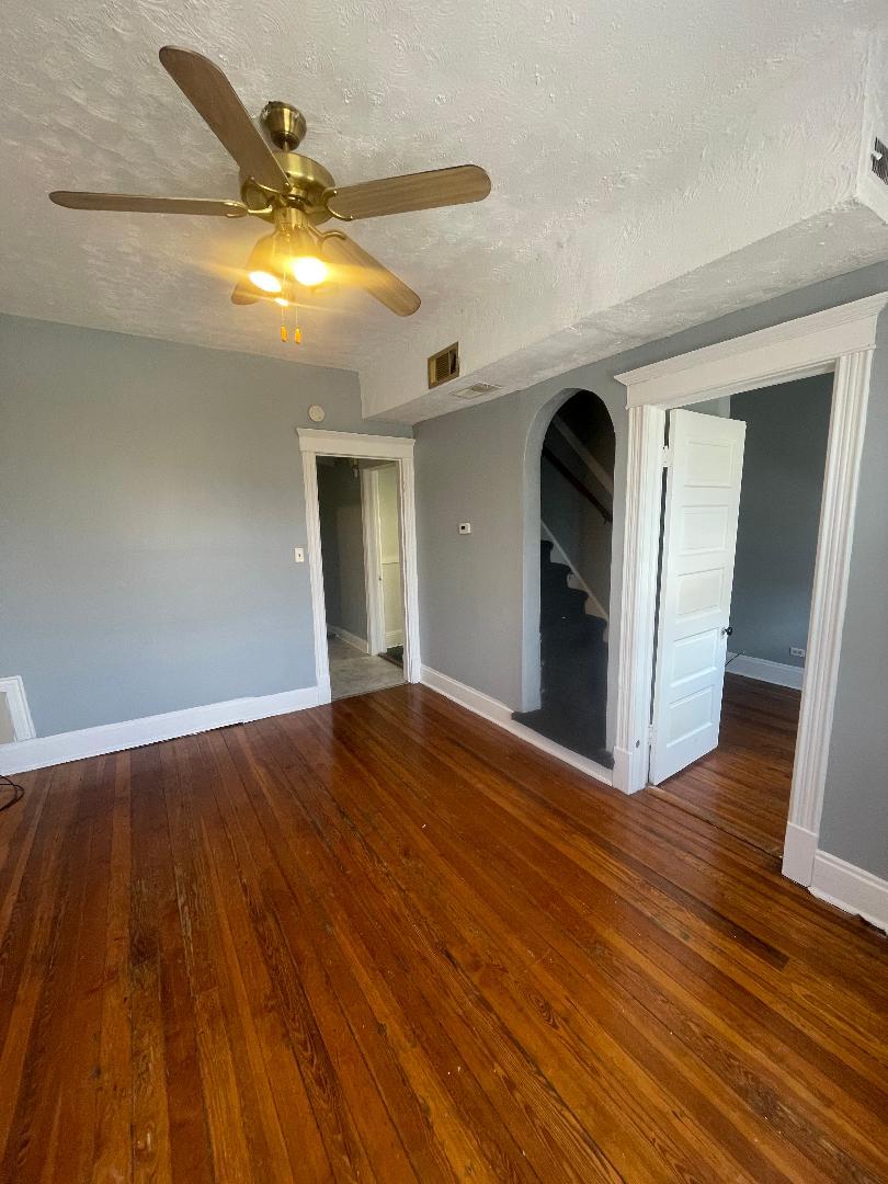 8136 South Exchange Avenue, Unit 2 Chicago, IL 60617 - Photo 2 of 8 a view of empty room with wooden floor
