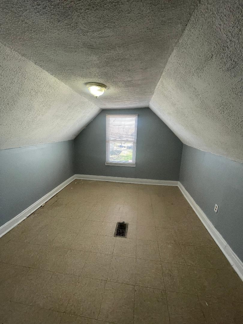 8136 South Exchange Avenue, Unit 2 Chicago, IL 60617 - Photo 7 of 8 an empty room with windows