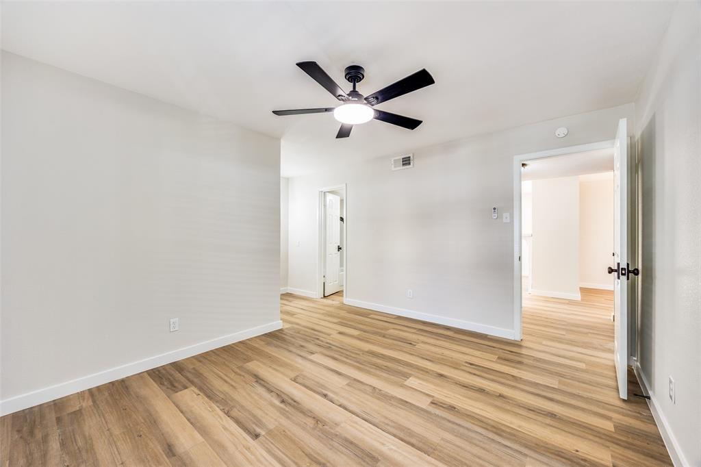 5300 Keller Springs Road, Unit 1067 Dallas, TX 75248 - Photo 11 of 14 a view of an empty room with wooden floor