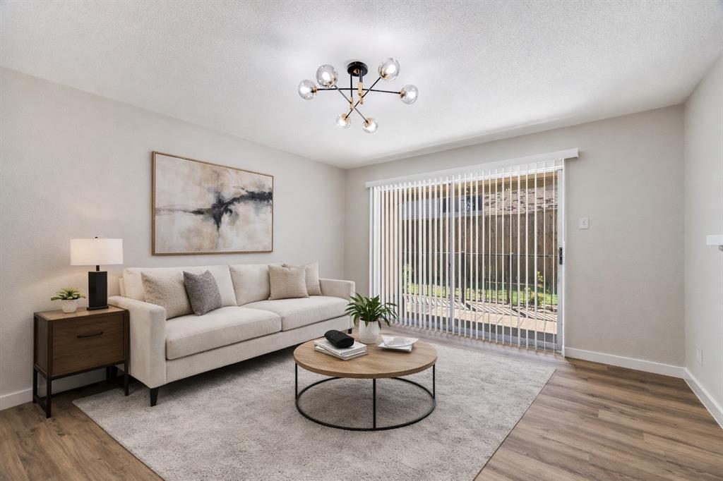 5300 Keller Springs Road, Unit 1067 Dallas, TX 75248 - Photo 3 of 14 a living room with furniture and a large window