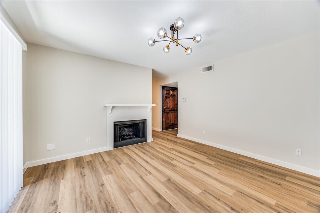 5300 Keller Springs Road, Unit 1067 Dallas, TX 75248 - Photo 5 of 14 a view of an empty room with a fireplace and a window
