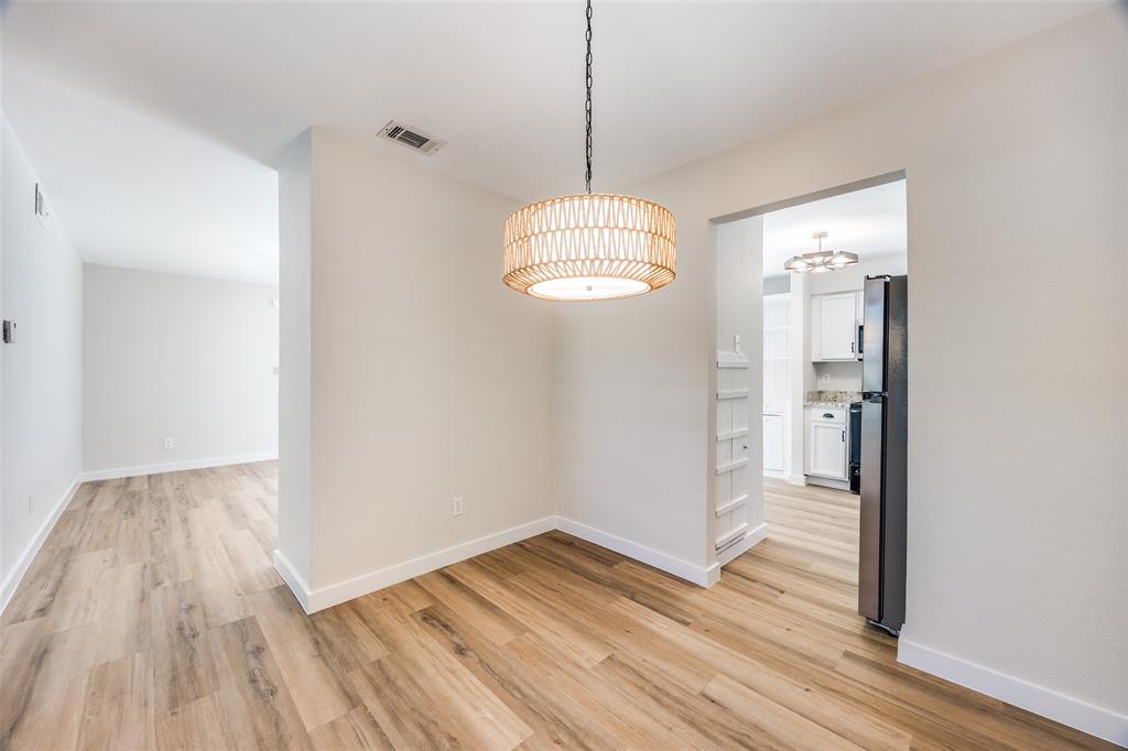 5300 Keller Springs Road, Unit 1067 Dallas, TX 75248 - Photo 7 of 14 a view of empty room with wooden floor and fan