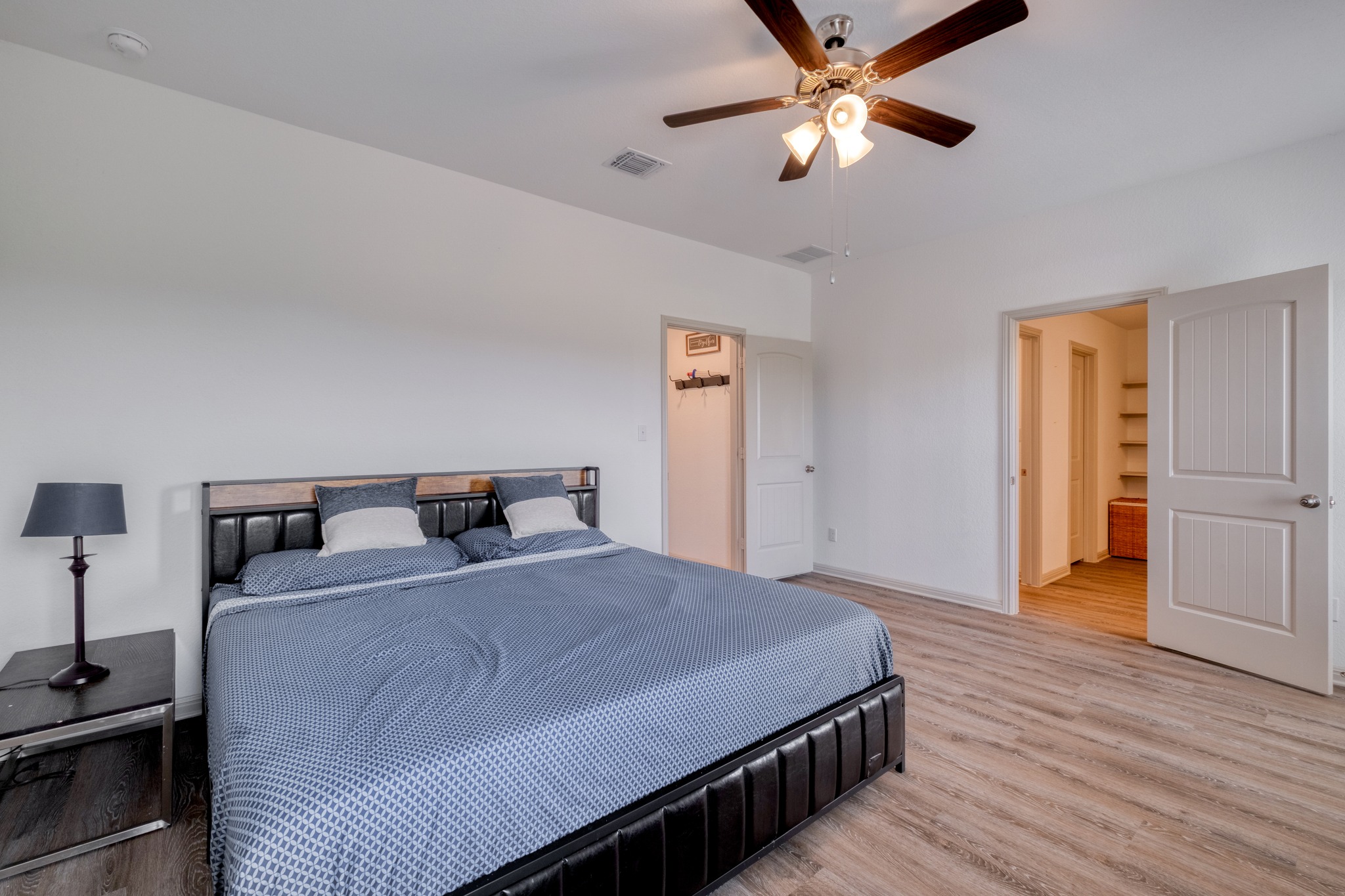 102 Johnson Draw Road Hutto, TX 78634 - Photo 16 of 30 Smooth wood-style flooring and minimalist lines define this spacious, airy bedroom retreat.