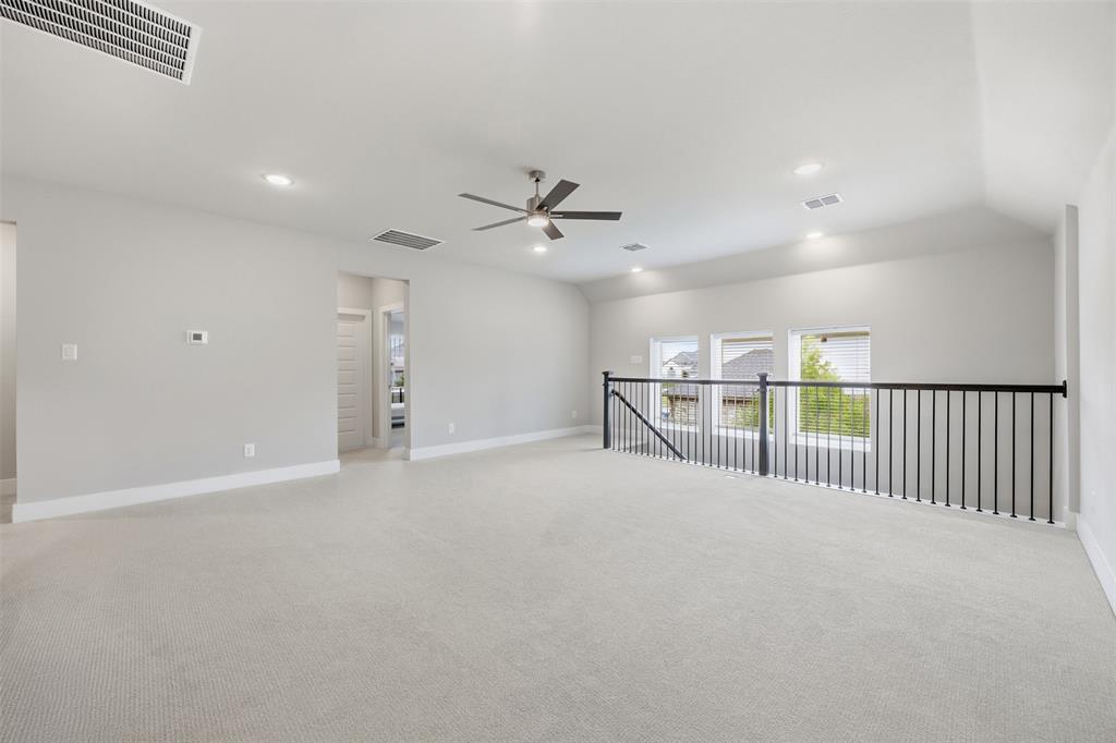 5805 Heatherwood Loop Sachse, TX 75048 - Photo 27 of 39 an empty room with windows and ceiling fan