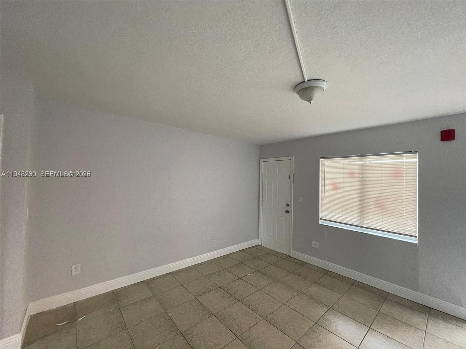2330 Northwest 11th Street, Unit 9 Miami, FL 33125 - Photo 6 of 18 a view of a room that has a window in it