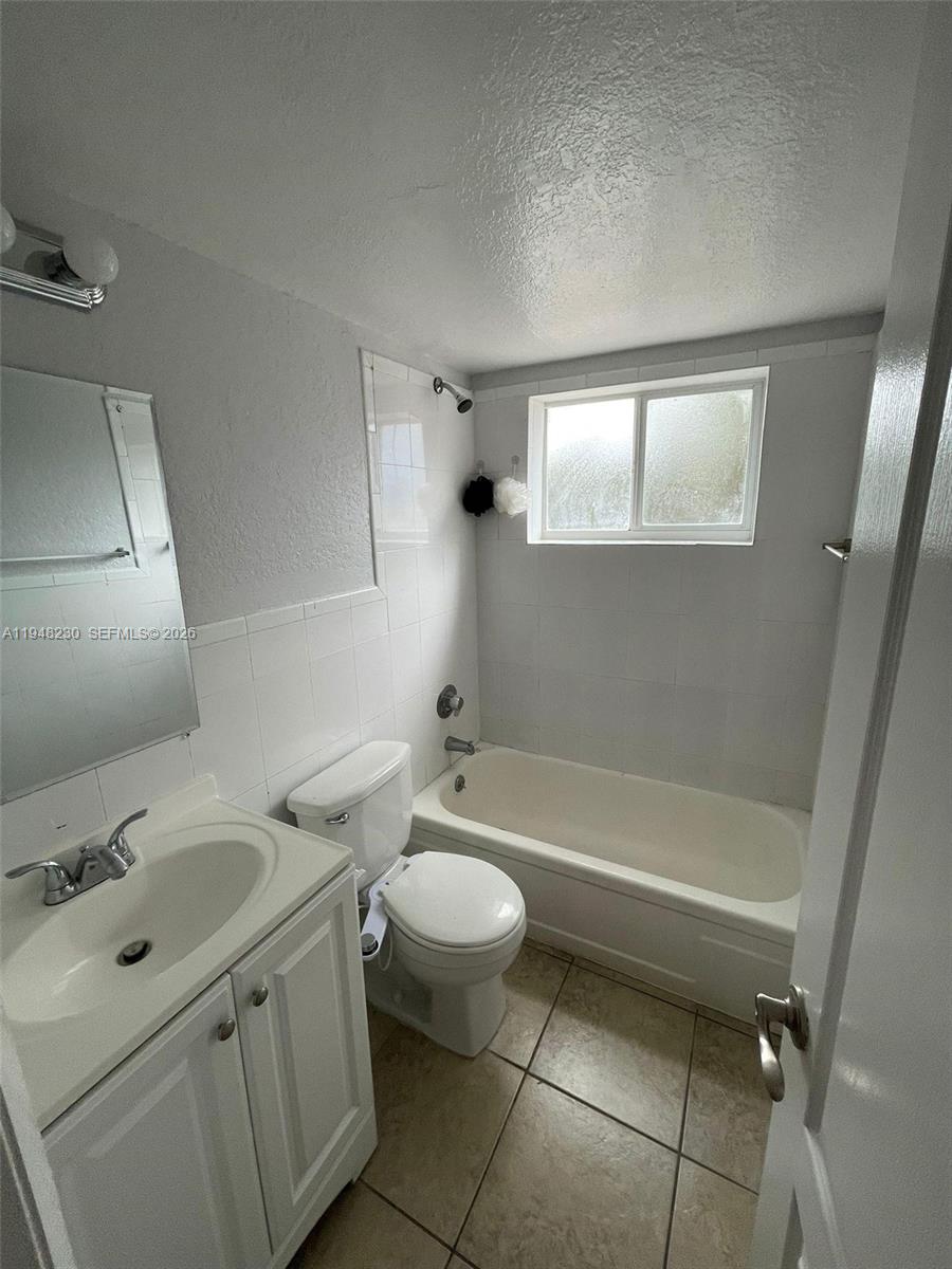 2330 Northwest 11th Street, Unit 9 Miami, FL 33125 - Photo 9 of 18 a bathroom with a sink toilet and shower