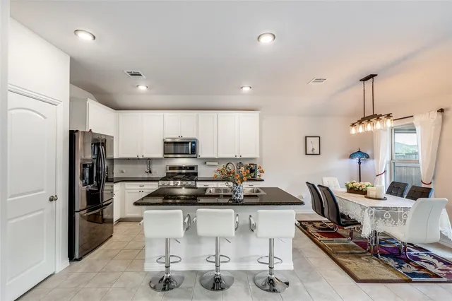 a kitchen with refrigerator and cabinets