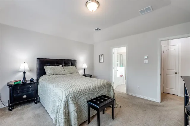 a bedroom with a bed and a night stand