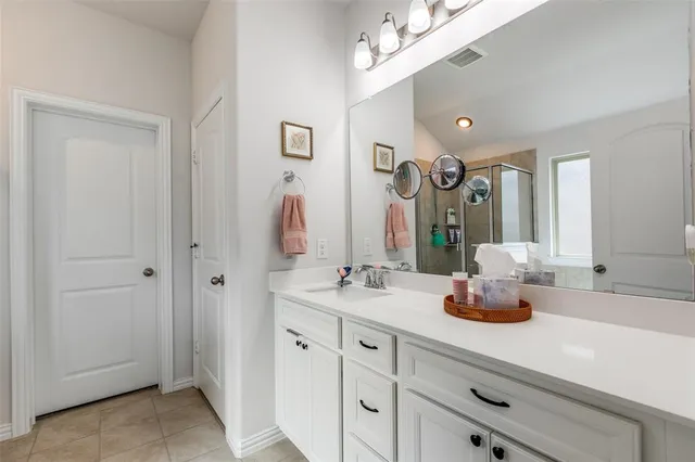 a bathroom with a sink double vanity and a mirror